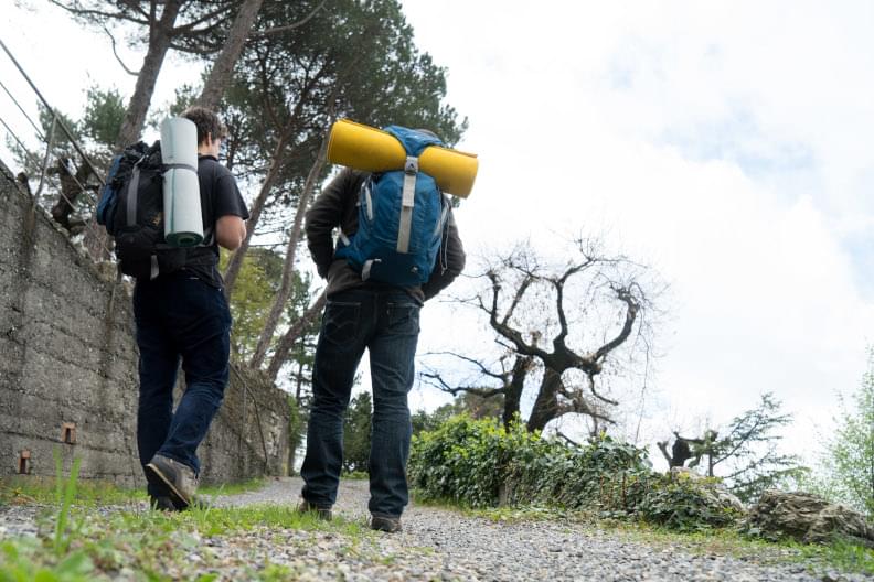 Young men walking on a mountain path