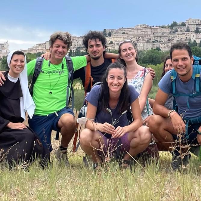 A Jesuits, a nun and a group of young women and men during a pilgrimage in Assisi, Italy